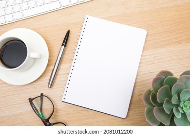 open notepad, cup of coffee, pen ,moose, keyboard on wooden background spiral notebook on table Business, planning, education, morning life working from home concept Top view Flat lay Mock up