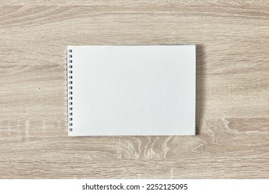 open notepad for notes on a wooden table with a copy space top view - Shutterstock ID 2252125095