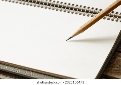 open notepad and pencil for notes, blank page, space for text