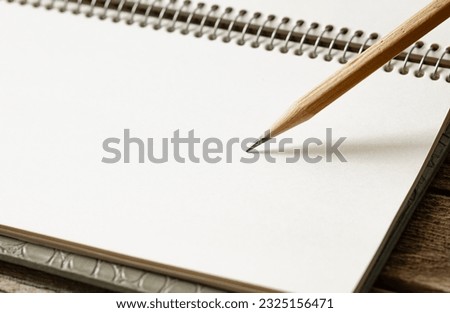 open notepad and pencil for notes, blank page, space for text