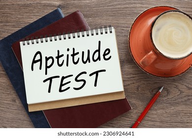 open notepad with spring. a cup of coffee. text APTITUDE TEST . Business concept - Shutterstock ID 2306924641