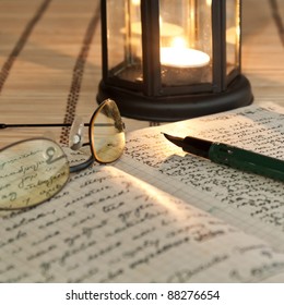 An Open Old Book By The Candlelight,close Up Photo