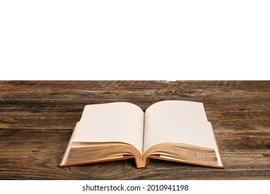 Open old book on table against white background