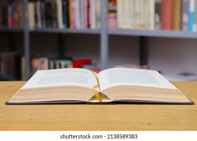 Open Old Book On The Table In Library