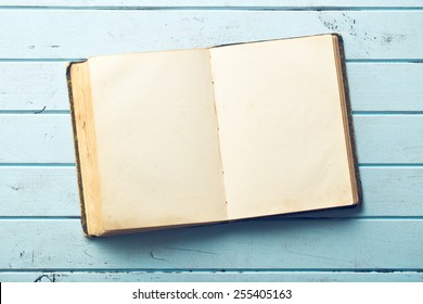 Open Old Book On Wooden Table