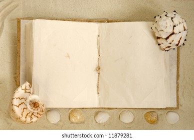 open old book with seashells on the sand - Powered by Shutterstock