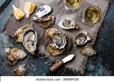 Open Oysters Fines de Claire with lemon and wine