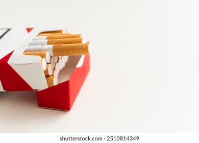 Open pack of cigarettes on a white background