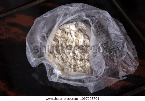 Open package with\
cocaine on a  table