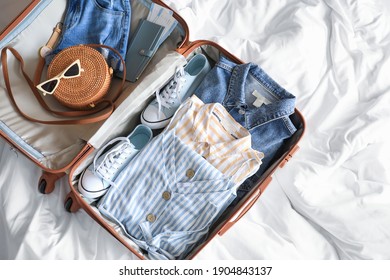 Open Packed Suitcase On Bed