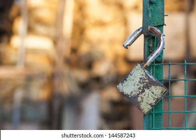 Open Padlock Hang On A Green Gate