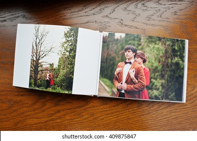 Open pages of album photobook couple in love on wooden background - Shutterstock ID 409875847