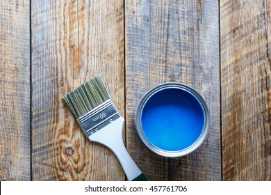 Open Paint Jar And Brush On Wooden Background Top View