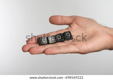 Open palm with four computer buttons with word UNDO
