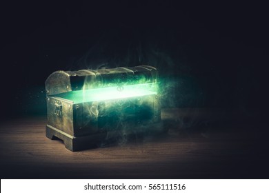 open pandora's box with green smoke on a wooden background /high contrast image
