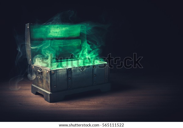 open pandora\'s box with green smoke on a\
wooden background /high contrast\
image\
