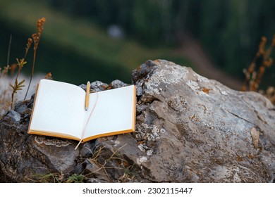 an open paper diary without notes. write down thoughts in nature in the old way