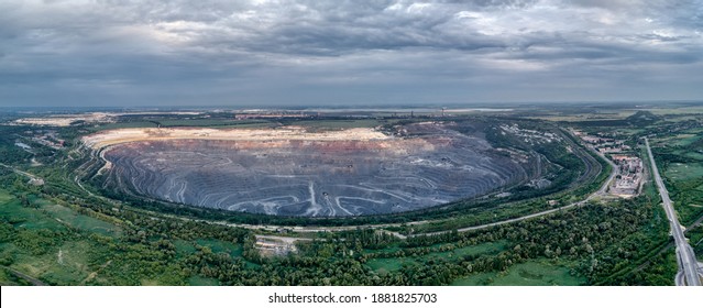 Open pit for the extraction of ore. Mining. Evening Panoramic shot from the air.