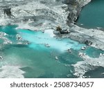 Open pit mine industry. Limestone quarry with backhoe and truck in operation. Heavy machinery in mining industry and construction material supply. Landscape of resource extraction in a industrial site