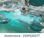 Open pit mine industry. Limestone quarry with backhoe and truck in operation. Heavy machinery in mining industry and construction material supply. Landscape of resource extraction in a industrial site