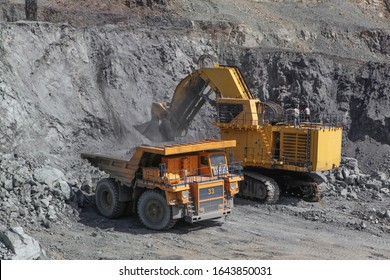 Open pit mining of iron ore and magnetite ores.Loading the iron ore into heavy dump truck at the opencast mining.