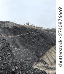 Open pit mining is a surface extraction technique used to remove minerals, coal, or rock from the earth by digging large, stepped, open holes (pits).

It is highly efficient for shallow, large volume deposits, allowing for the use of heavy machinery like trucks and excavators to maximize production and reduce costs, though it causes significant environmental disruption.
