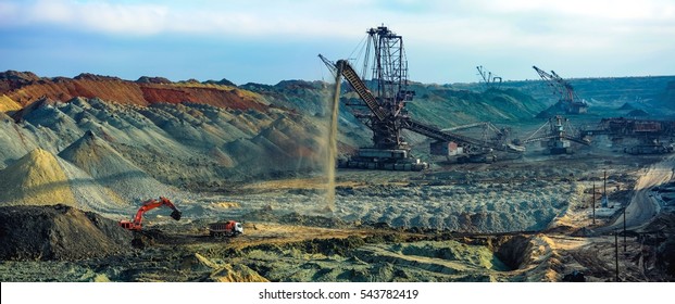 Open pit. Opencast manganese ore mine. Giant excavator machinery. Extractive industry. Big mine, develop mineral resources, excavator digs, metallurgy in Ukraine