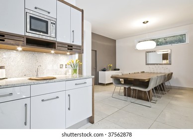 open plan dining room with kitchen area and sitting for ten