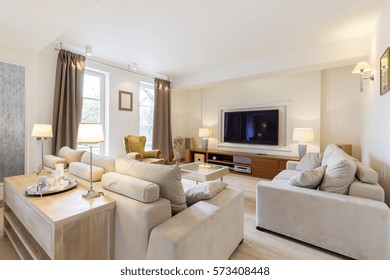 Open plan of a relaxing area with couches, coffee table and TV set - Shutterstock ID 573408448
