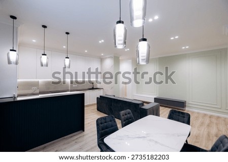 Open plan space featuring elegant marble table and pendant lighting