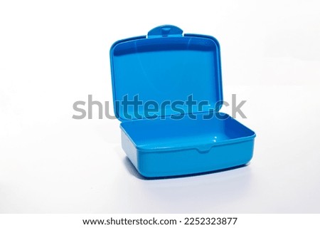 Open plastic lunch box on white background, food container for school
