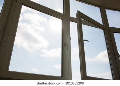 Open plastic vinyl window at the background of blue sky - Shutterstock ID 1013553298