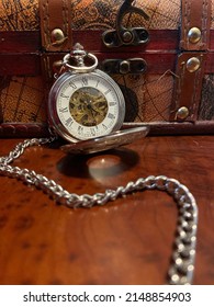 Open Pocket Watch Resting On Travel Box