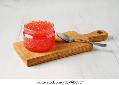 Open pot with pink salmon red caviar 