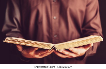 Open Quran Holy Book In Human Hand