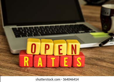 Open Rates written on a wooden cube in a office desk