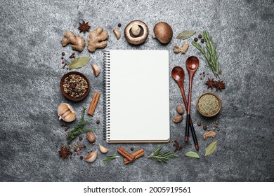 Open Recipe Book And Different Ingredients On Grey Table, Flat Lay. Space For Text