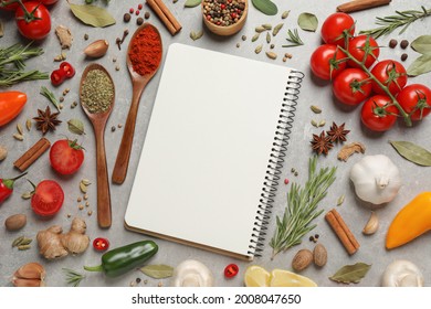 Open Recipe Book And Different Ingredients On Grey Table, Flat Lay. Space For Text