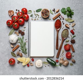 Open Recipe Book And Different Ingredients On Grey Table, Flat Lay. Space For Text