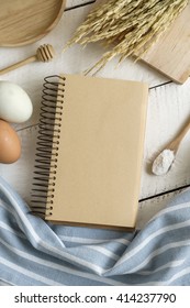 Open Recipe Book On White Wooden Table, Top View