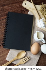 Open recipe book on wooden table with copy space, Top view - Shutterstock ID 496744201