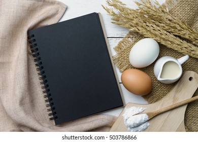 Open Recipe Book On Wooden Table With Copy Space, Top View