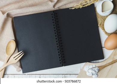 Open Recipe Book On Wooden Table With Copy Space, Top View