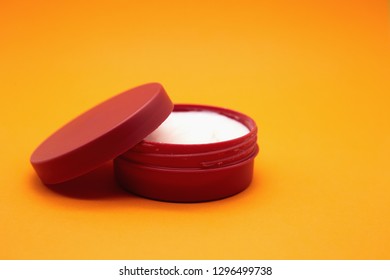 Open Red Cosmetic glass jar isolated. Jar with Skin care bottles for gel, lotion, cream. Orange background. - Shutterstock ID 1296499738