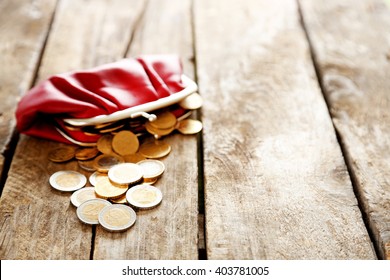 Open Red Purse And Euro Coins On Wooden Table