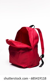 Open red school backpack on white background
