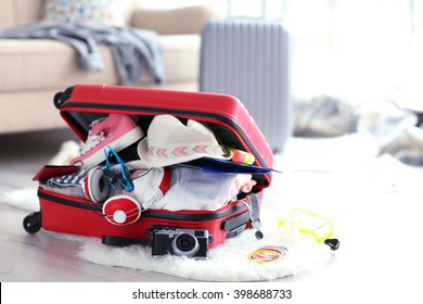 Open Red Suitcase On The Floor, Close Up