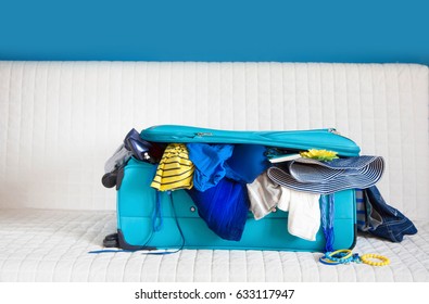 Open Red Suitcase On The Sofa, Close Up