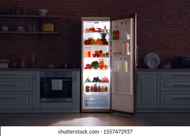 Open Refrigerator In Dark Modern Kitchen