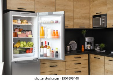 Open Refrigerator Full Of Products In Kitchen